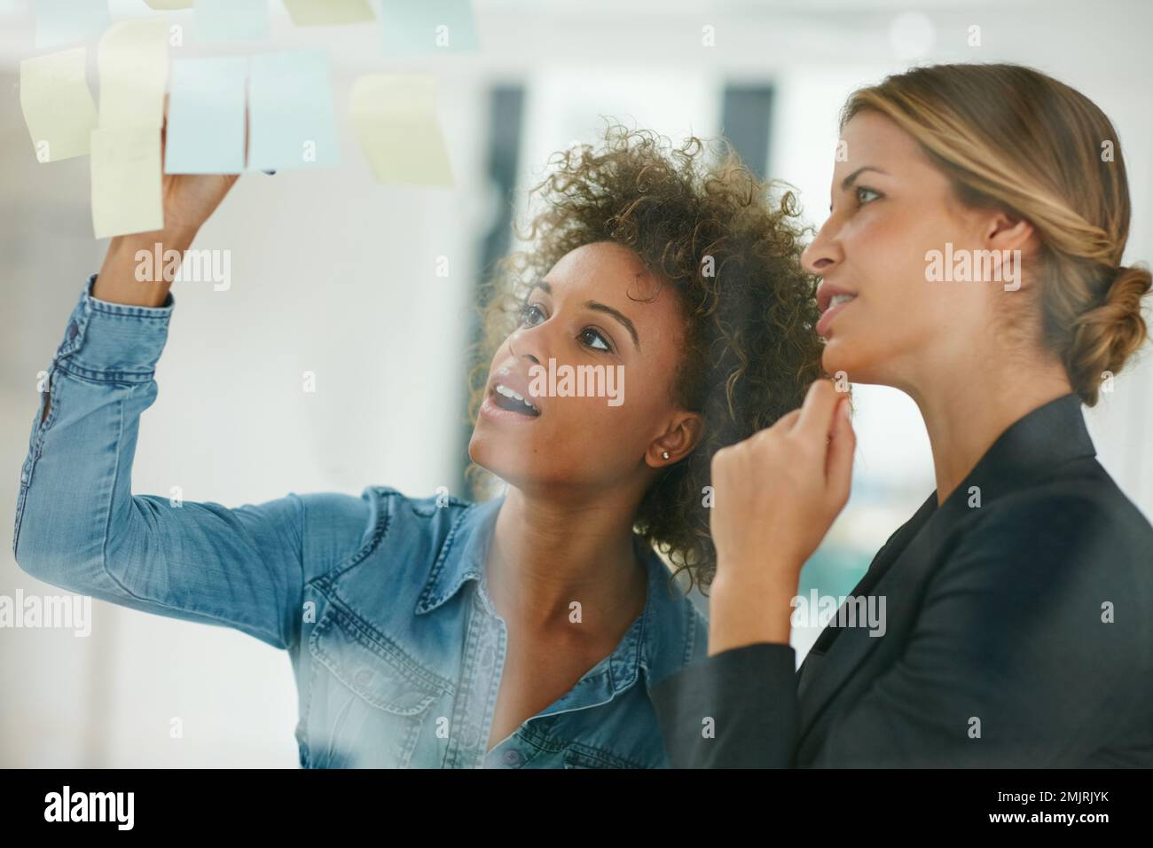 You wont get anywhere without a vision. coworkers using sticky notes