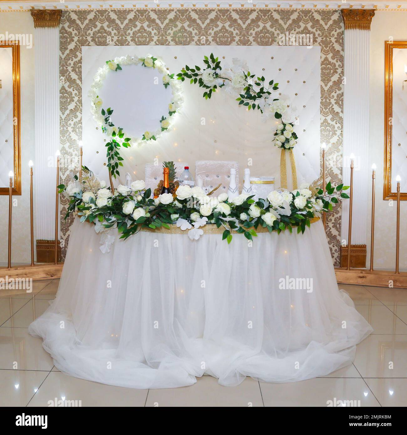 Table and wall decoration with fresh flowers for the bride and groom