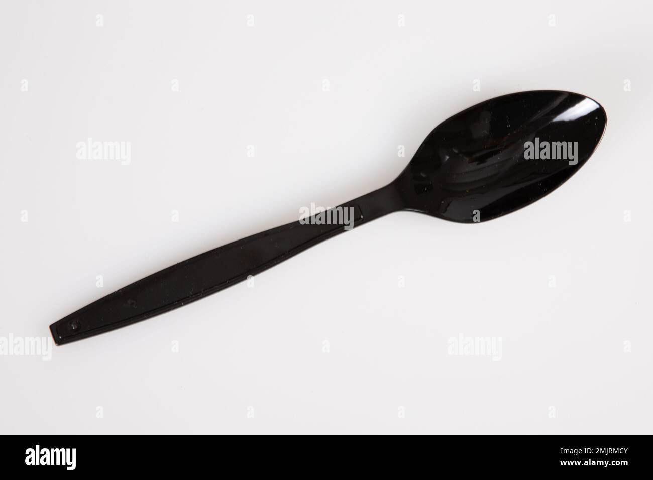 black spoon plastic recyclable biodegradable top view isolated on white