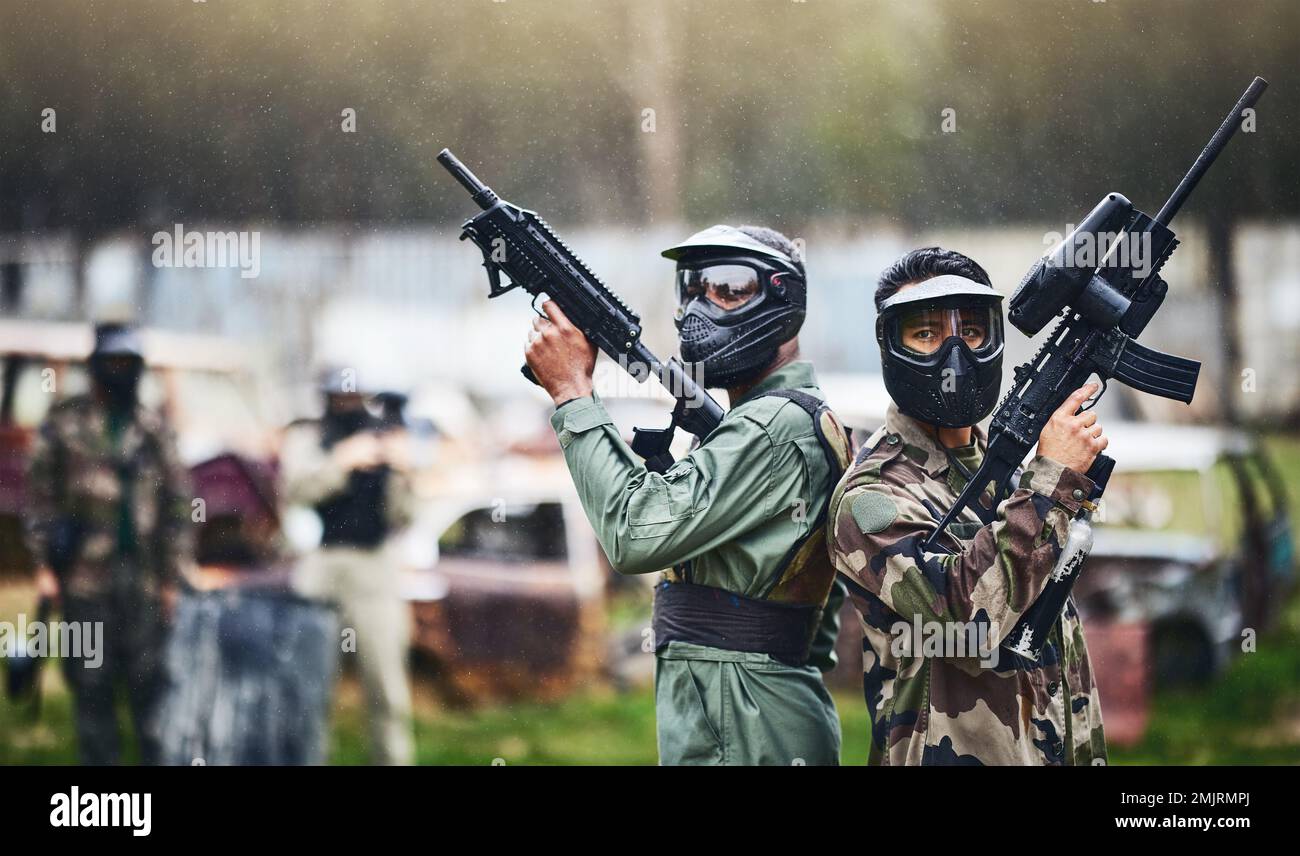 Paintball, ready or people in a gun shooting games with war action in playground battlefield on