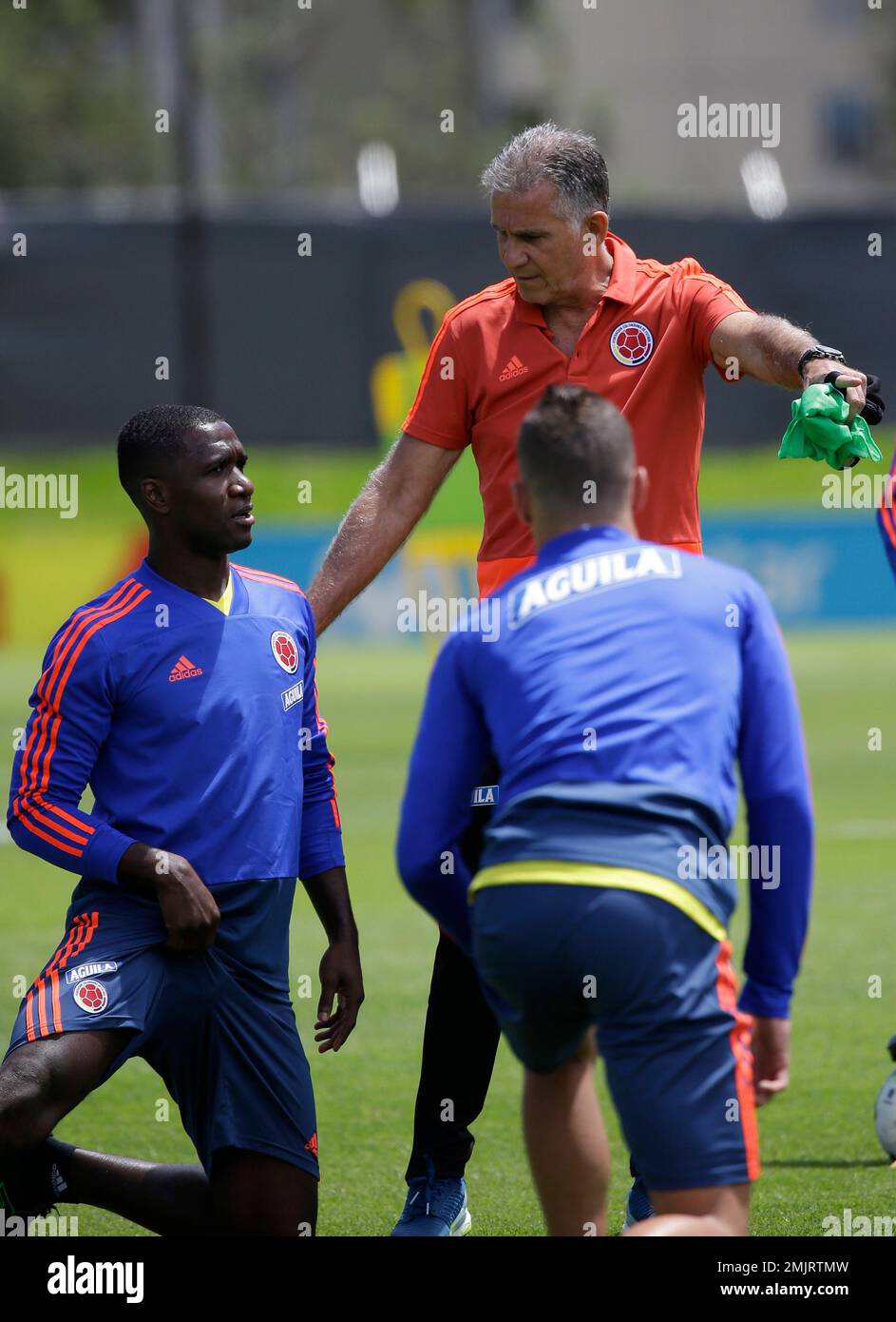 Colombia's national soccer coach Carlos Queiroz, top right, talks to  Cristian Zapata, left, during a training session of the national soccer  team in Bogota, Colombia, Wednesday, June 5, 2019. Colombia will play