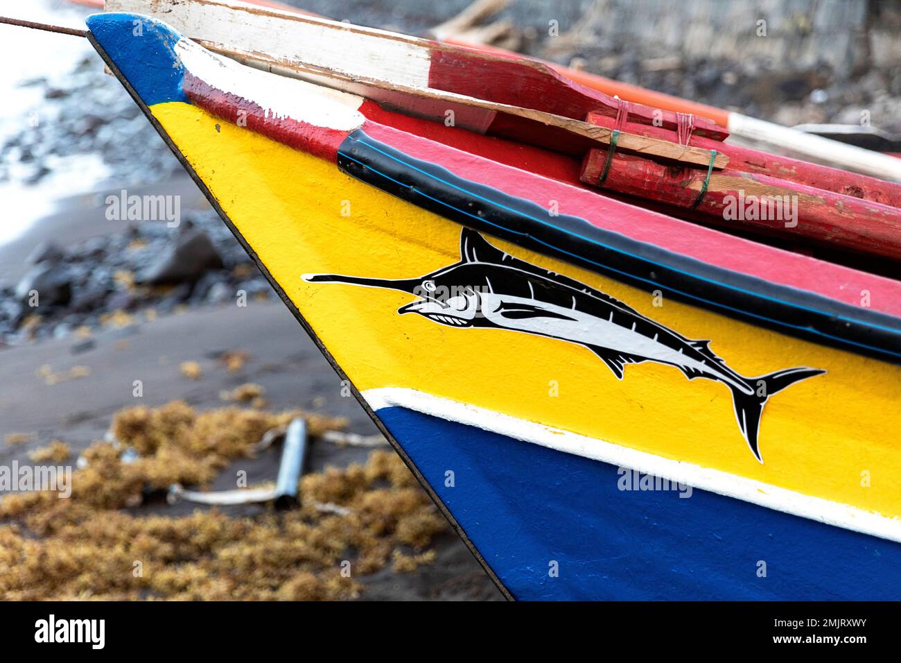 Painting on a Traditional fishing wooden boat at the beach in Cidade Velha, Santiago island, Cabo verde, Cape verde Stock Photo