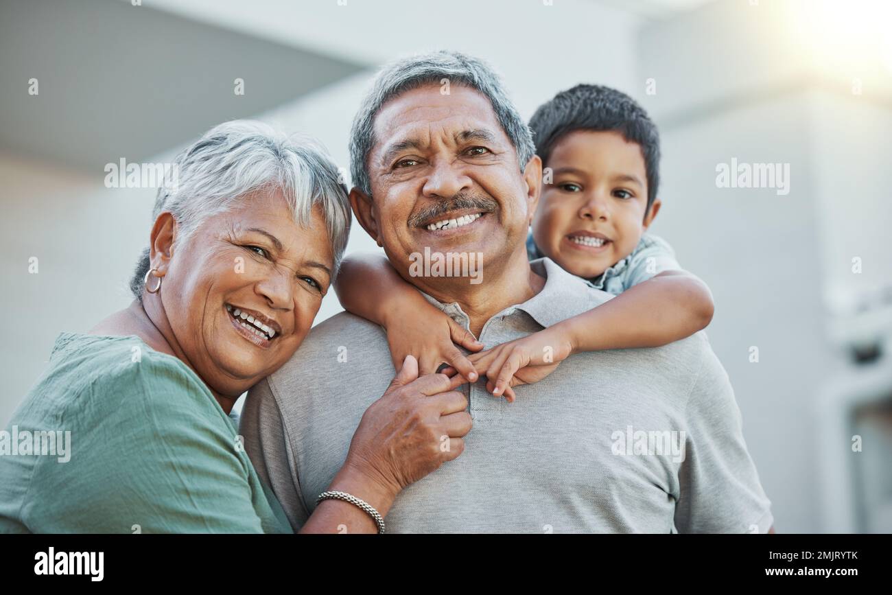 Grandpa, grandma and child hug with smile for happy holiday or weekend break with grandparents at the house. Portrait of elderly people holding Stock Photo