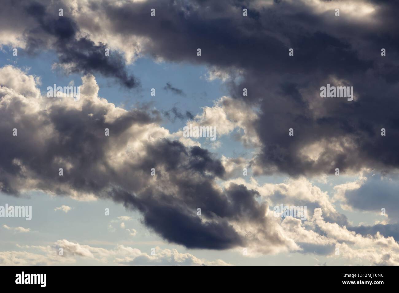 Dramatic rain clouds with blue sky in the background Stock Photo