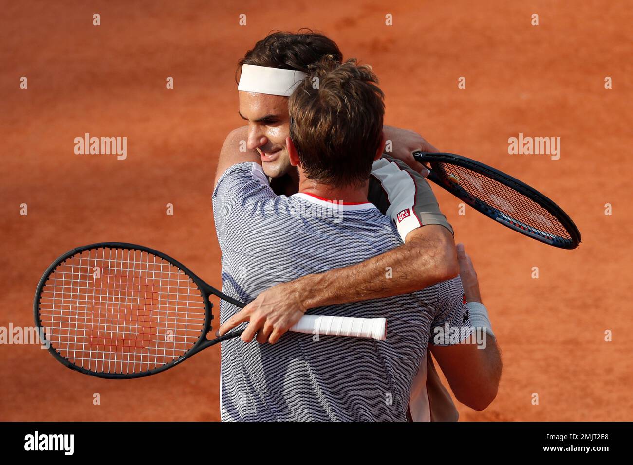 Switzerland's Roger Federer and Stan Wawrinka hug after their quarterfinal  match of the French Open tennis tournament which Federer won in four sets,  7-6 (7-4), 4-6, 7-6 (7-5), 6-4, at the Roland