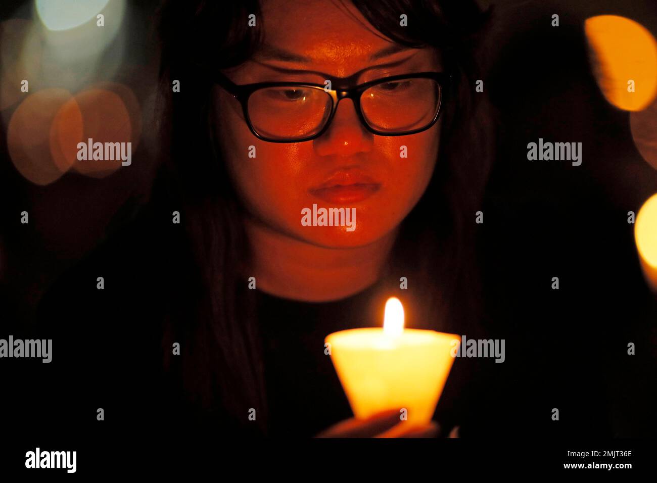 Thousands of people attend a candlelight vigil for victims of the ...
