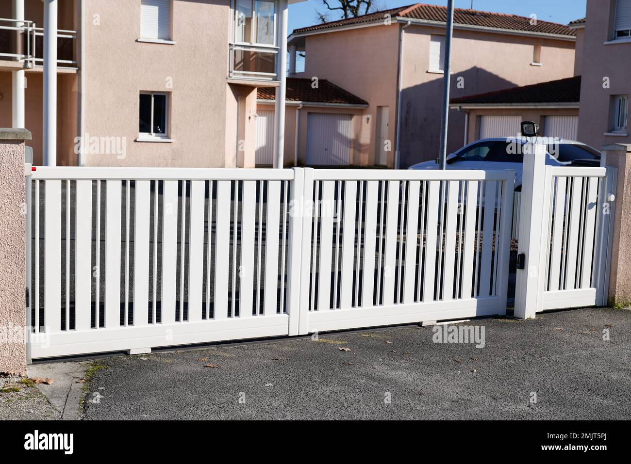 white classical home apartment door aluminum gate sliding slats portal garden entry suburb house Stock Photo