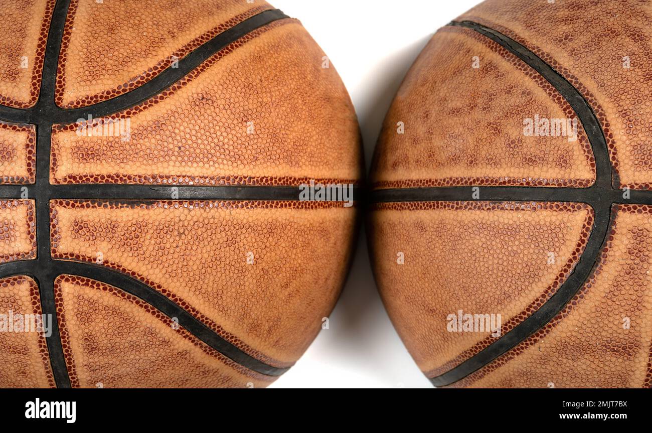 two parts of a cut out basketball on white background Stock Photo Alamy