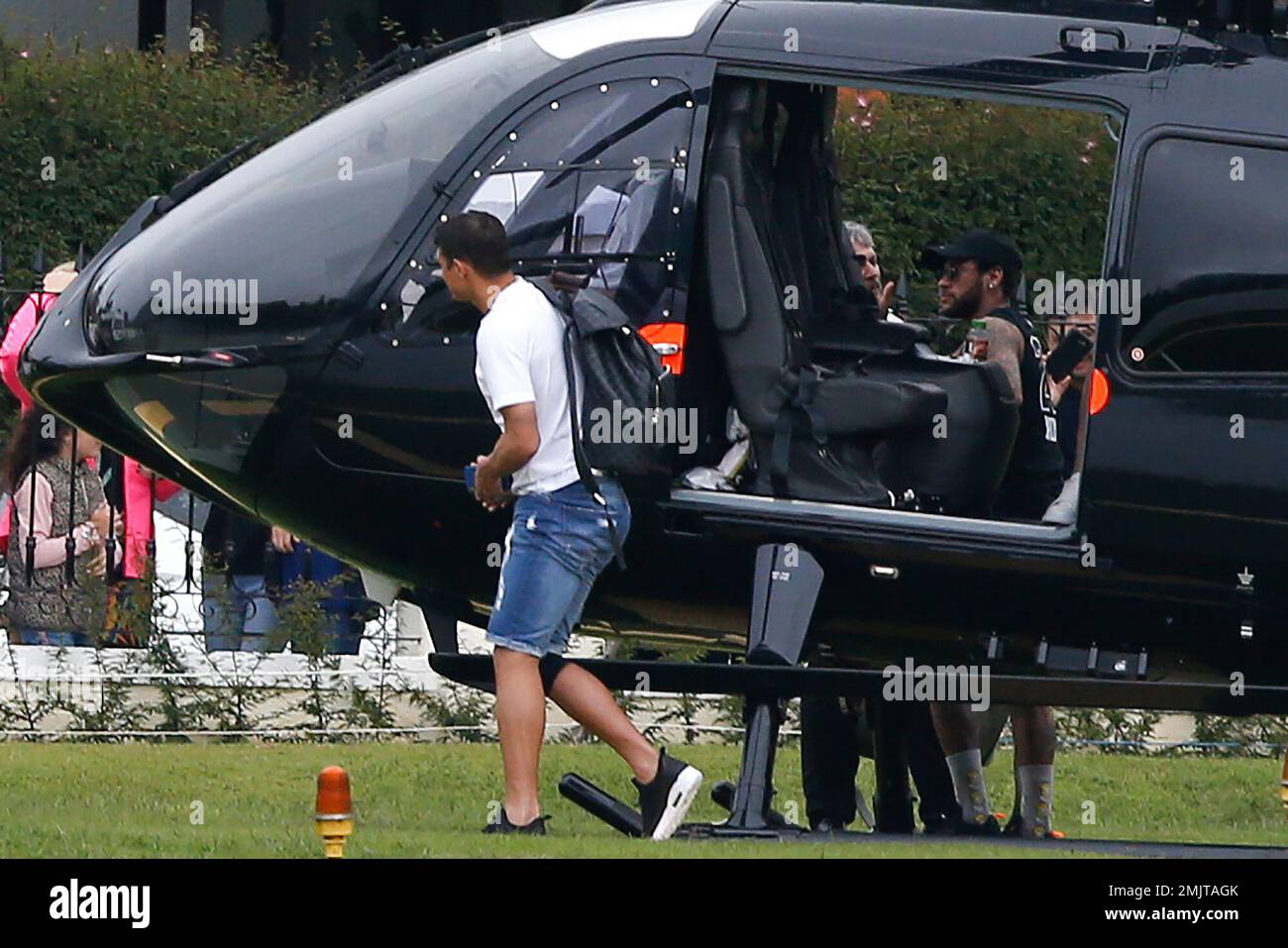 Brazil's soccer player Neymar, right, behind door, and teammate Thiago  Silva, front left, exit Neymar's helicopter that transported them to the  Granja Comary training center for training ahead of the Copa America