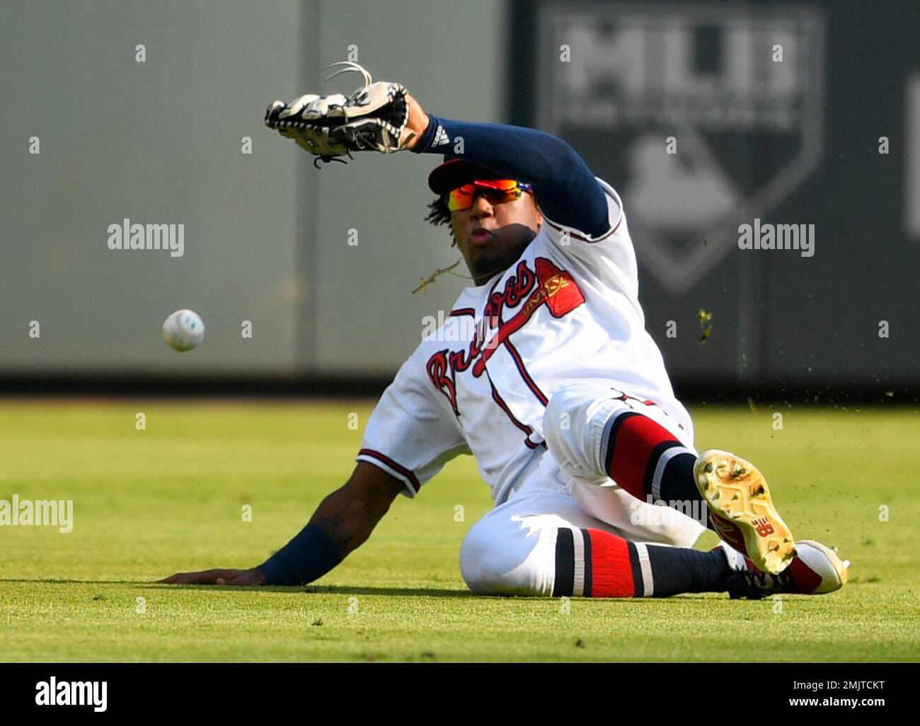 Atlanta Braves center fielder Ronald Acuna Jr. (13) can't keep a glove on a  ball off the bat of Detroit Tigers' Brandon Dixon who doubled during the  eighth inning of a baseball