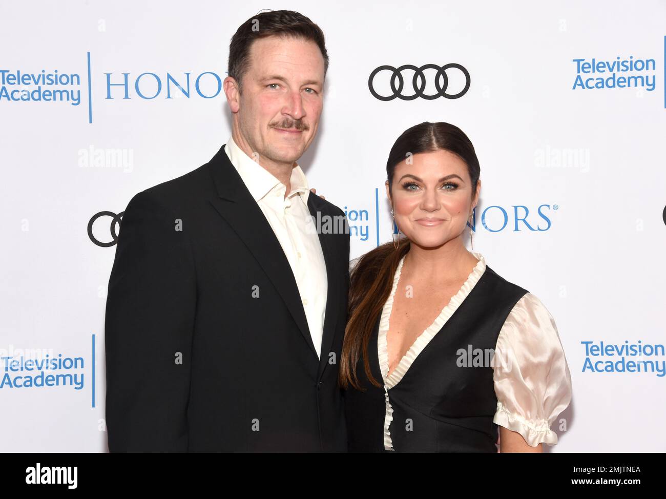 Brady Smith, left, and Tiffani Thiessen arrive at the 12th Annual