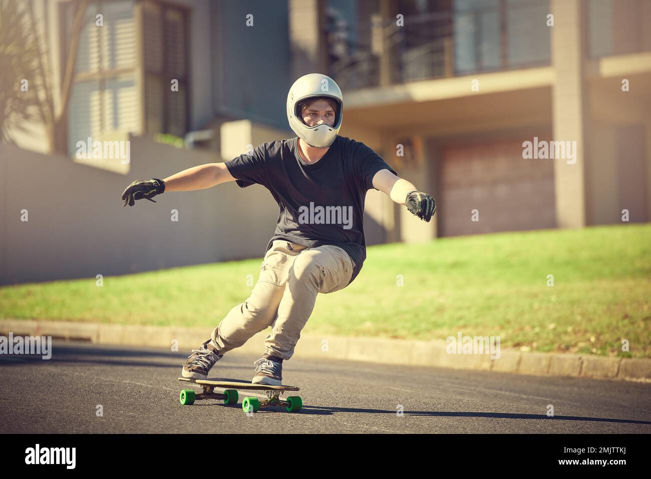 Skateboard, training or mockup with a sports man skating on a street  outdoor while moving at speed for action. Fitness, exercise and road with a  male Stock Photo - Alamy