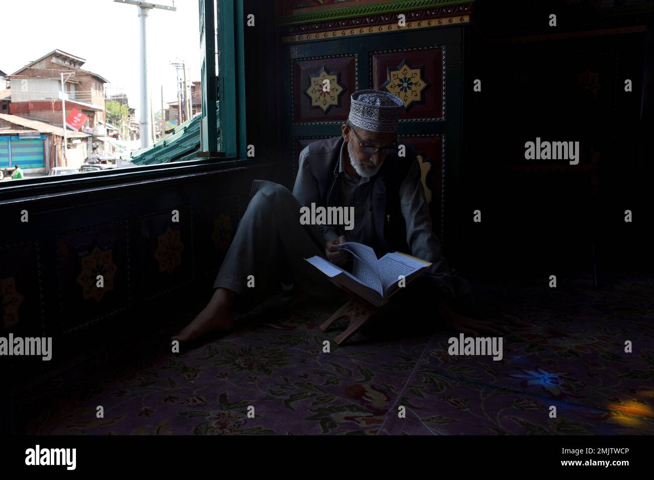 A Kashmiri man reads verses from holy Quran inside the shrine of Sufi ...