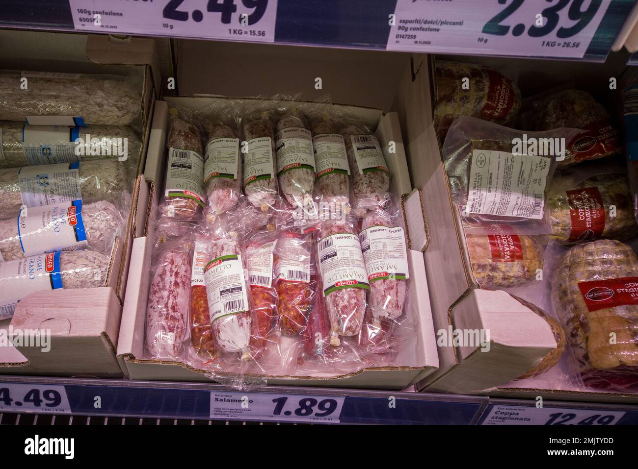 Italy - January 28, 2023: Packaged Milano type salami for sale on the salami shelf of the Italian supermarket Stock Photo