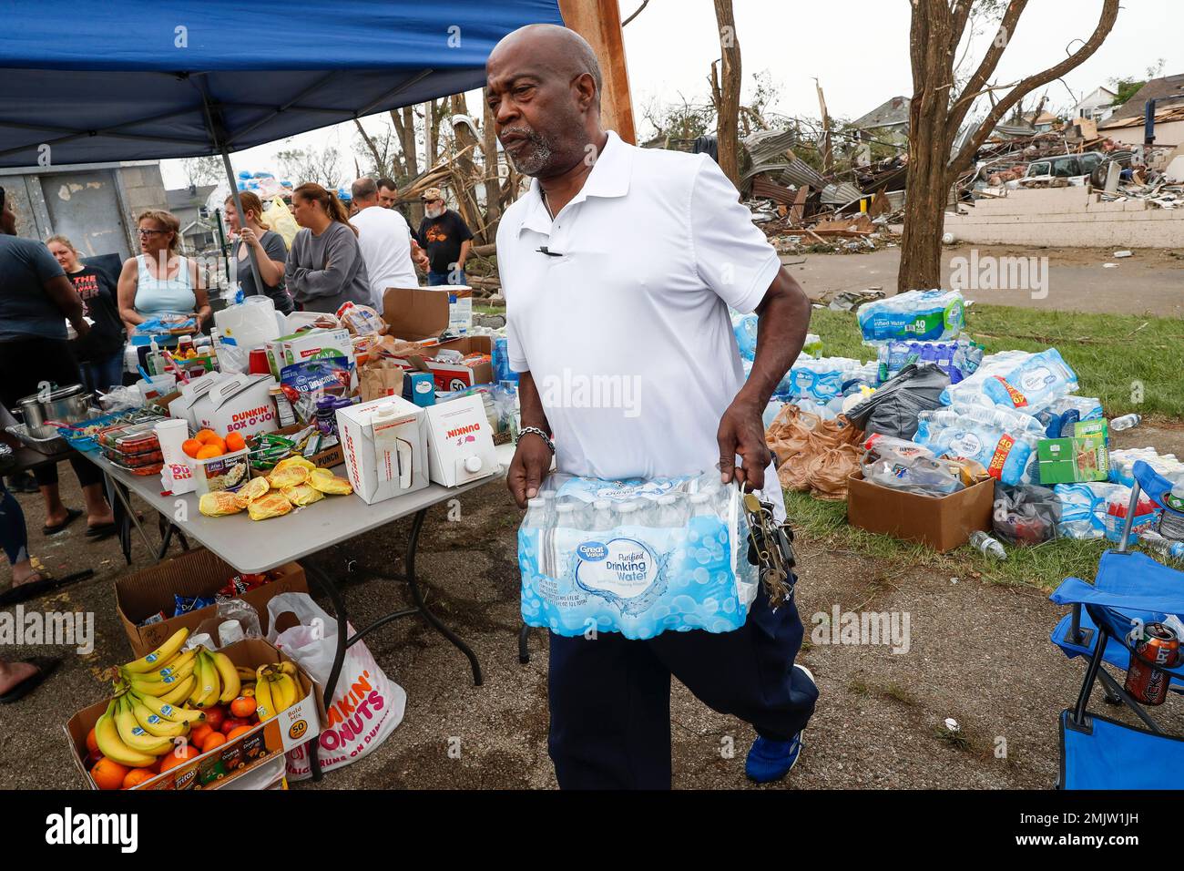Local volunteers help organize relief support for victims of a tornado