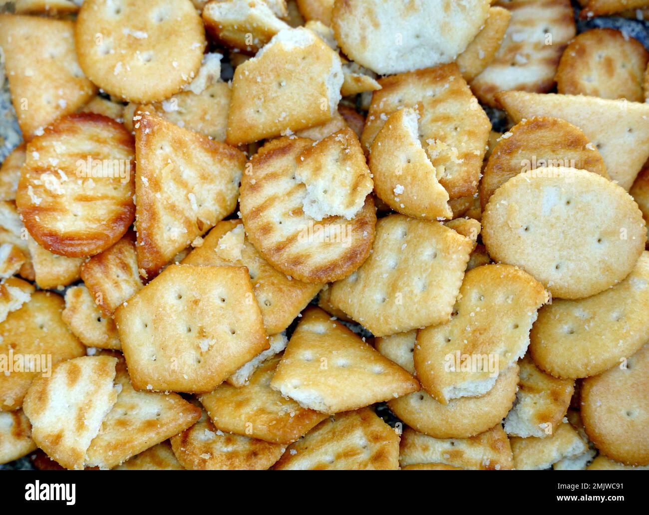 Broken cracker isolated on white background. Crushed dry cracker cookies isolated with clipping