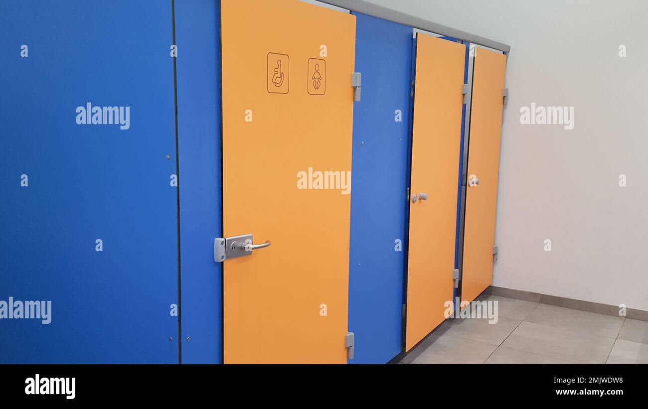 Empty door public toilet interior blue yellow color Stock Photo