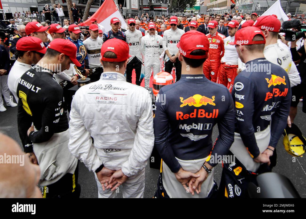 The drivers wear red 'Niki' hats during a minute of silence to tribute F1  legend Niki Lauda prior the Monaco Formula One Grand Prix race, at the  Monaco racetrack, in Monaco, Sunday,