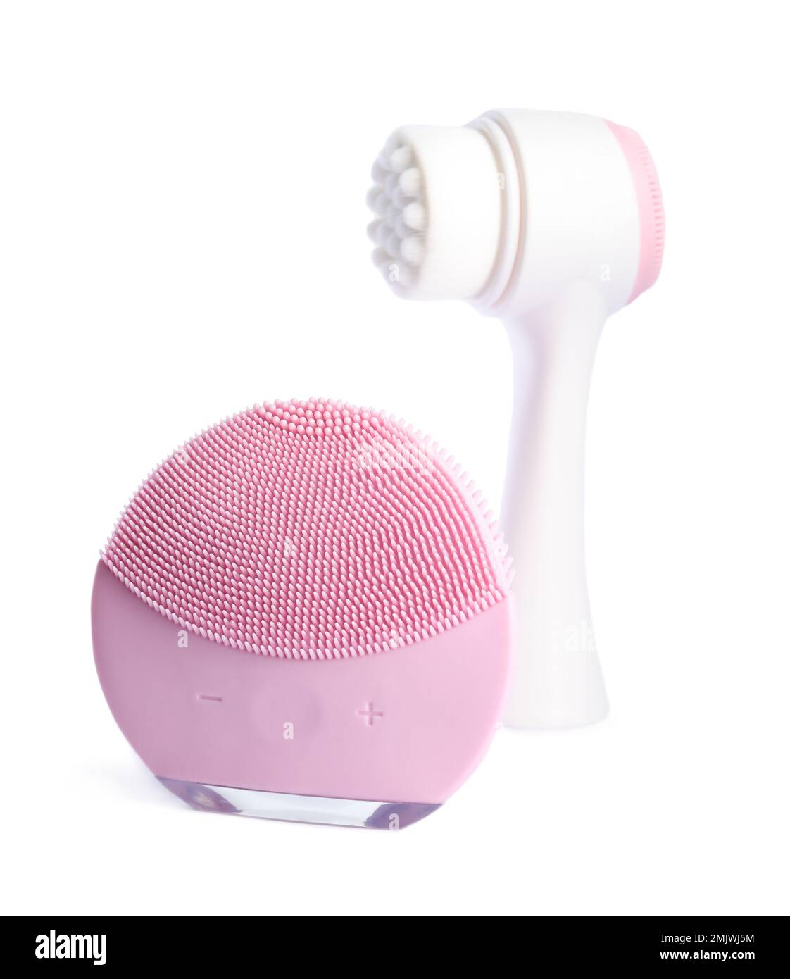 Modern electric face cleansing brushes isolated on white. Cosmetics