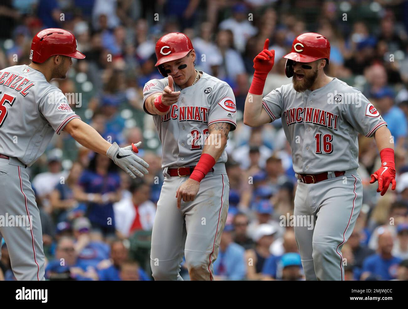 Cincinnati Reds' Eugenio Suarez, left, celebrates with Derek Dietrich after  hitting a solo home run off Miami Marlins pitcher Wei-Yin Chen during the  sixth inning of a baseball game Tuesday, April 9