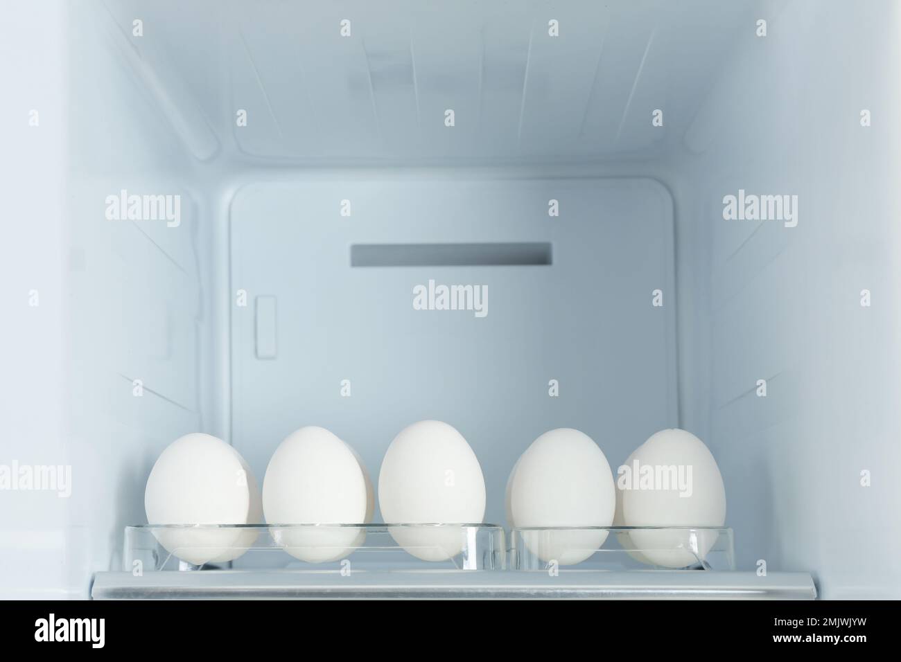 Fresh eggs on shelf in modern refrigerator Stock Photo Alamy