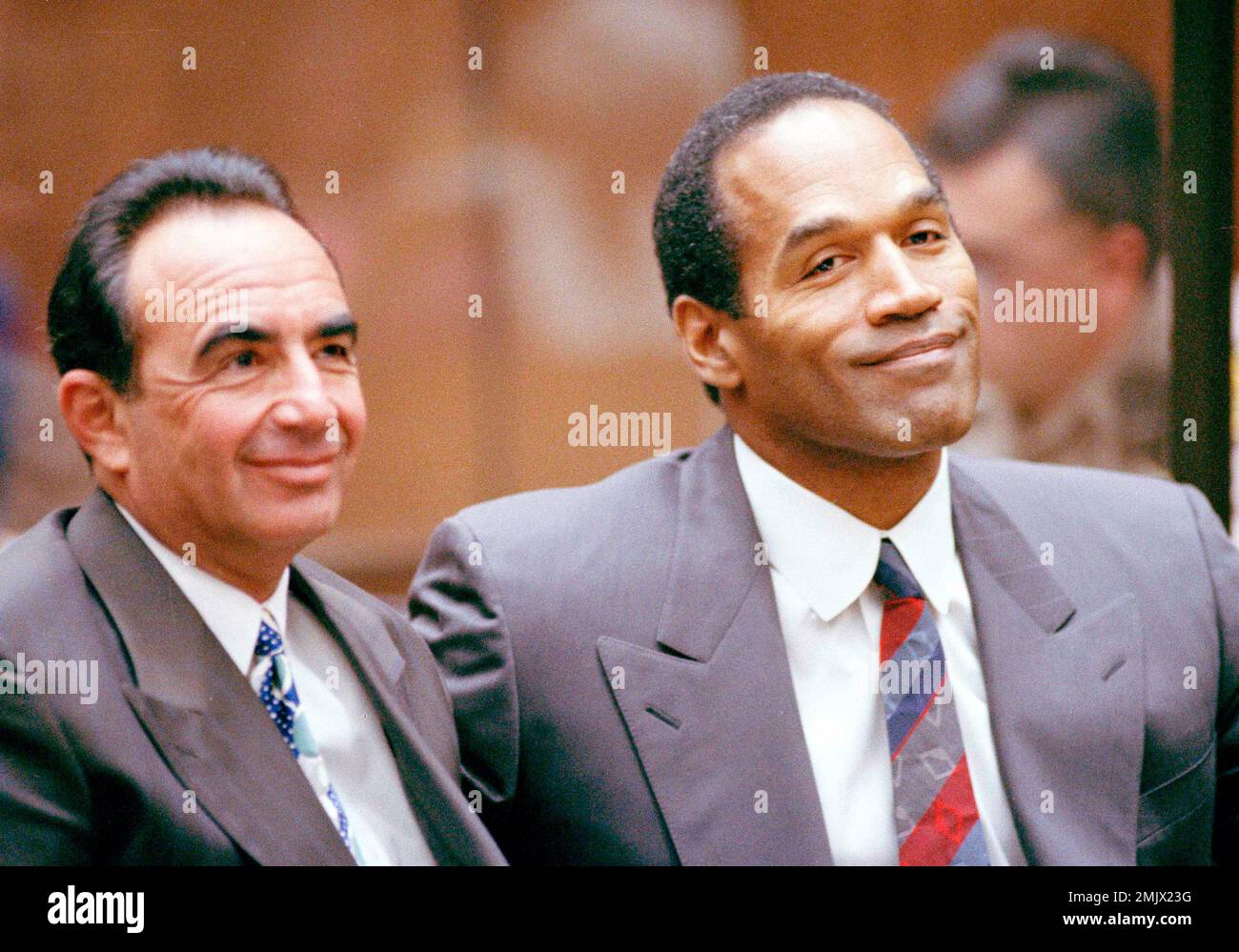 O.J. Simpson and his lawyer Robert Shapiro smile during hearing in Los Angeles court room, July