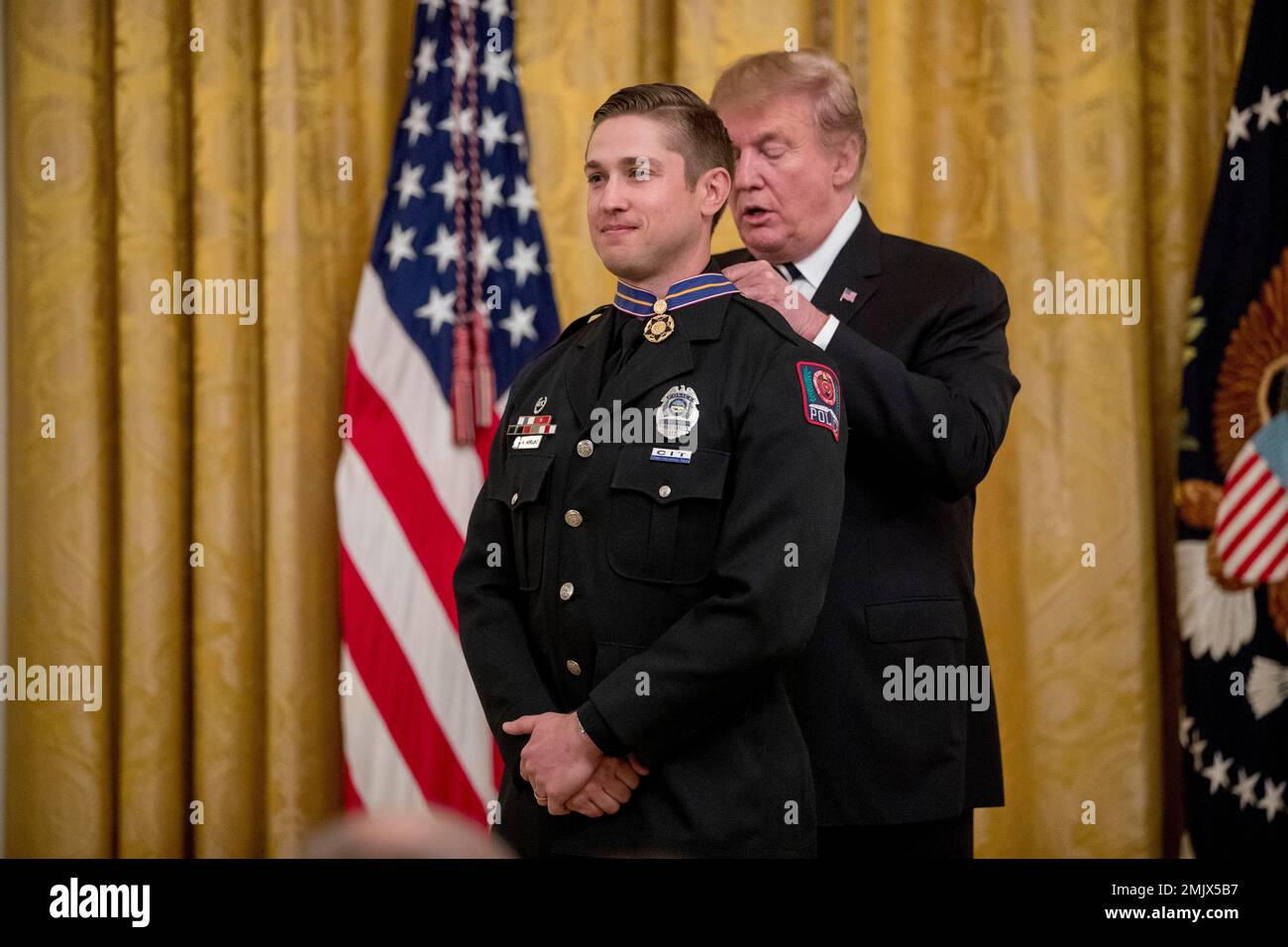 President Donald Trump awards Ohio State police officer Alan Horujko of