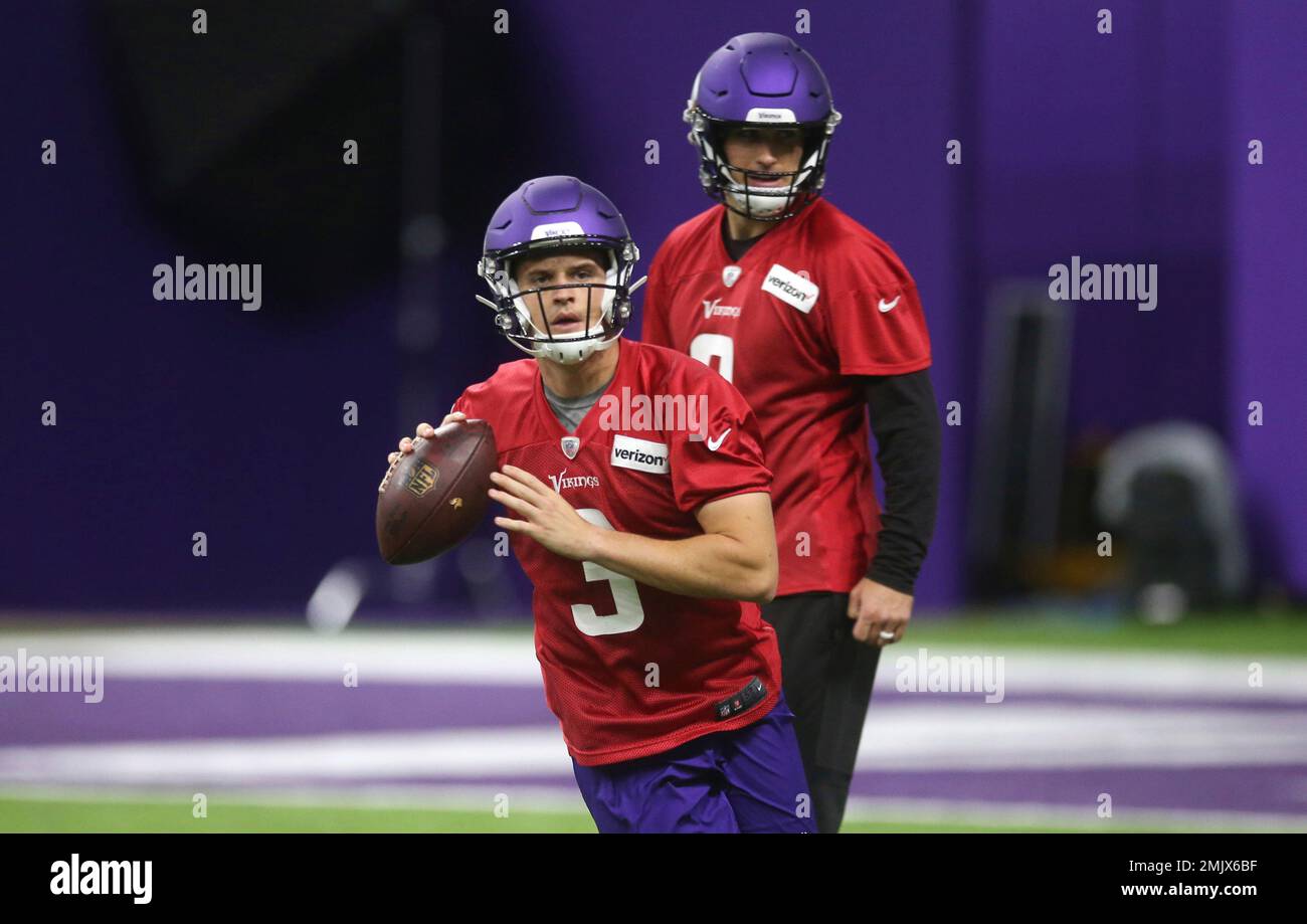 Minnesota Vikings NFL football quarterback Kirk Cousins, right, watches