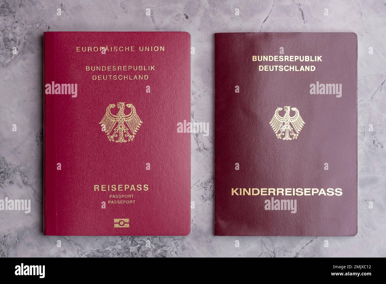 German and Turkish passports on the marble floor. Travel to Germany. Travel documents and passports. Visa paper. Stock Photo