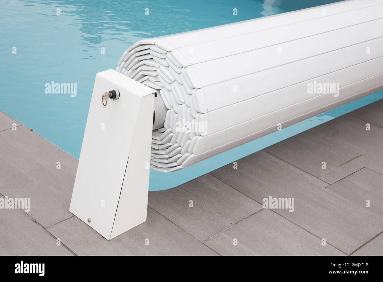 Pool rigid cover rolled up on a roller swiming Stock Photo Alamy
