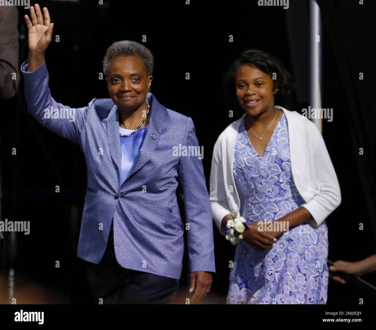 Mayor of Chicago Lori Lightfoot, left, arrives on stage with her daughter Vivian during her