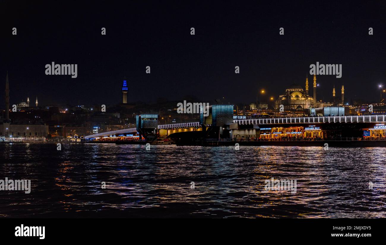 Istanbul, Turkey, 01.20.2023: Night view of Galata bridge. Istanbul night landscapes. Mosques and estuary. Istanbul evenings. Golden Horn metro bridge Stock Photo