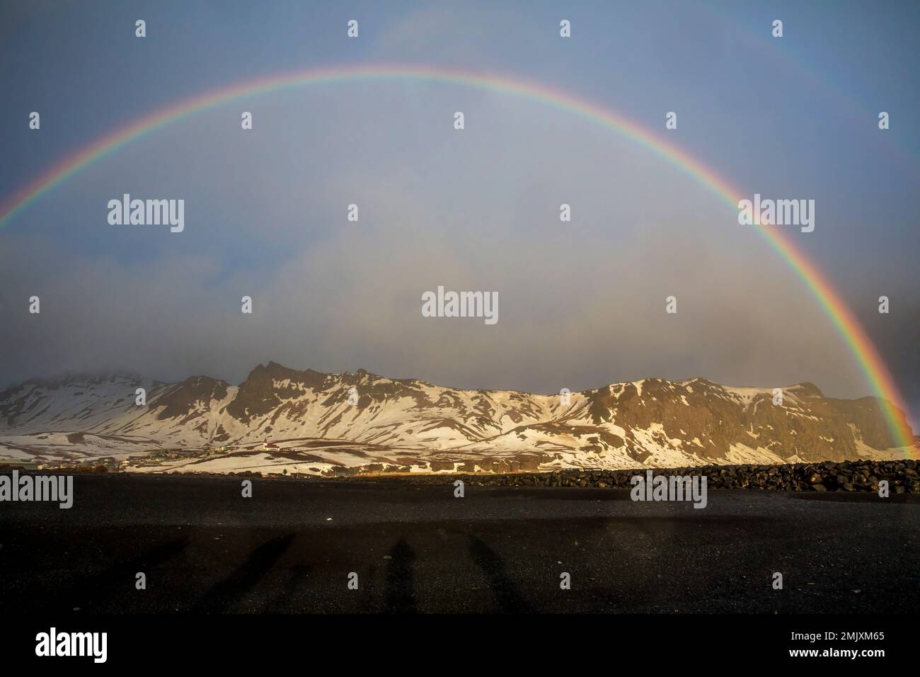 Rainbow over snow capped mountains in Iceland Stock Photo