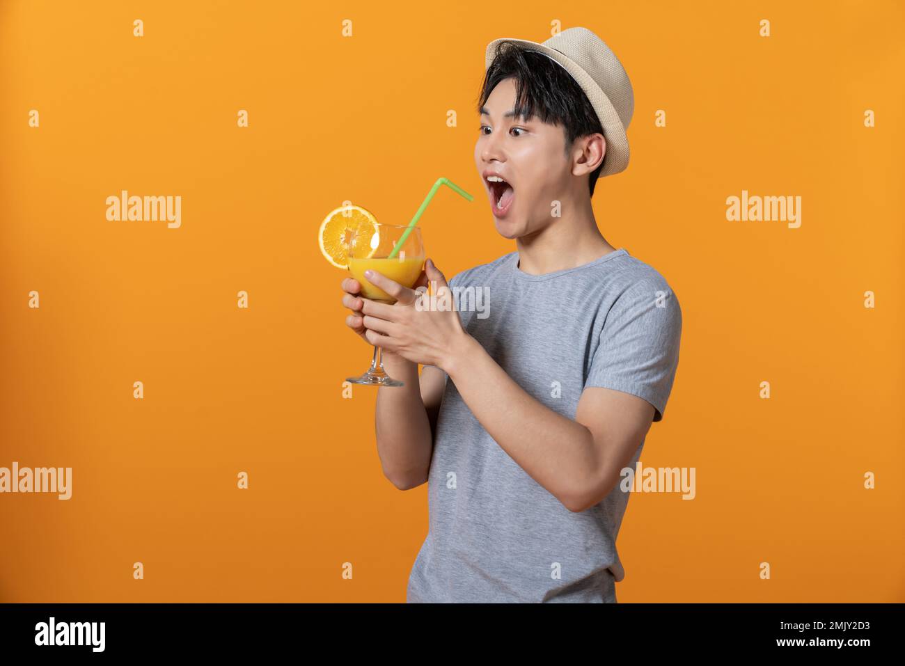 Young men drink orange juice Stock Photo Alamy
