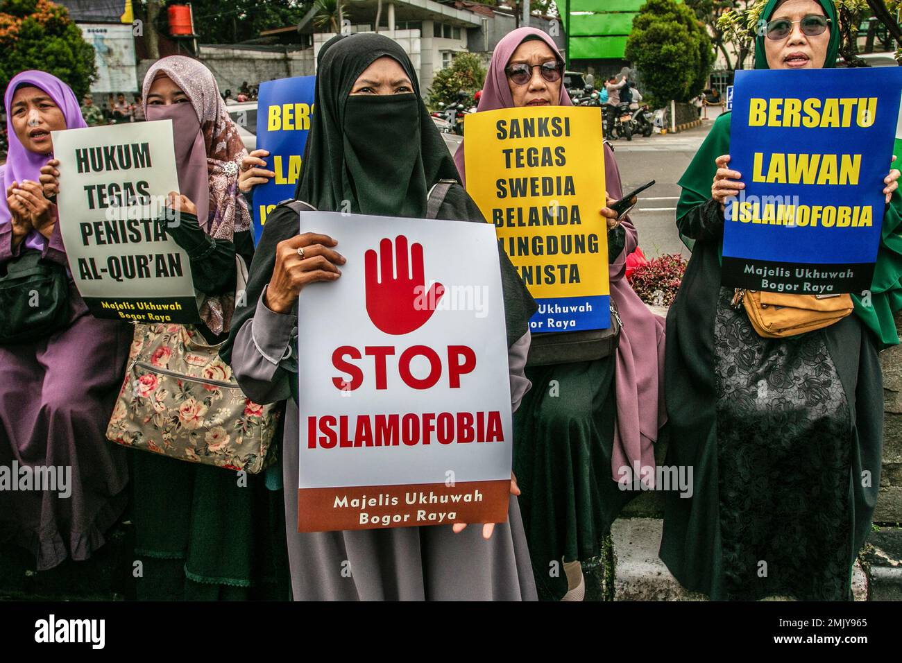 Bogor, Indonesia. 27th Jan, 2023. Indonesian Muslim women hold a placard during a protest against Swedish-Danish to denounce the recent desecration of Islam's holy book, Quran, by a far-right politician Rasmus Paludan, in Bogor, West Java, Indonesia on January 27, 2023. The global Islamic community condemned Islamophobia after Swedish-Danish far-right politician Rasmus Paludan burned a copy of the Koran at a rally in Stockholm on 21 January. (Photo by ANDI M RIDWAN/INA PHOTO AGENCY/SIPA USA) Credit: Sipa USA/Alamy Live News Stock Photo