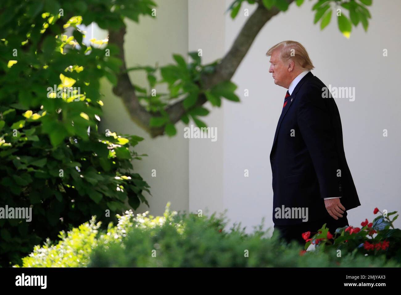 President Donald Trump walks from the Oval Office as he leaves White ...