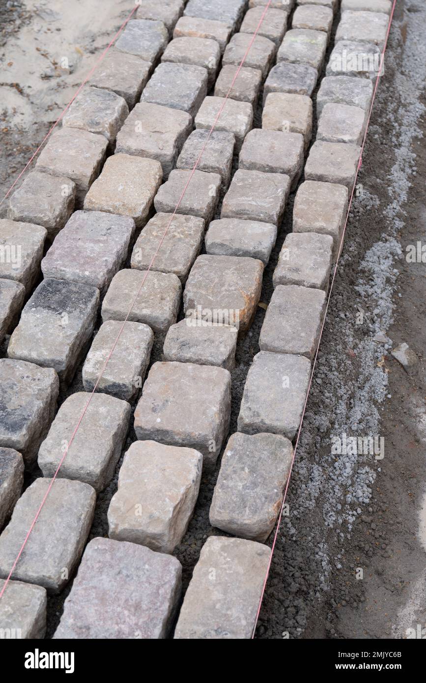 paved street under construction placing the edging Stock Photo Alamy