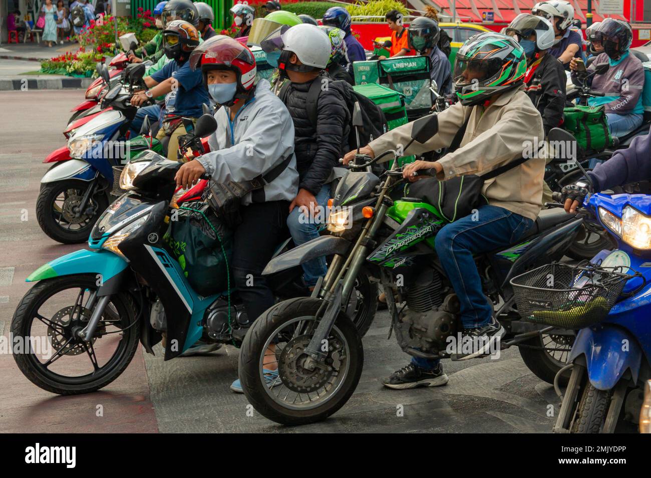 Busy Bangkok traffic waiting for the traffic lights to change on Asok Montri Road at the interchange with Sukhumvit Road Stock Photo