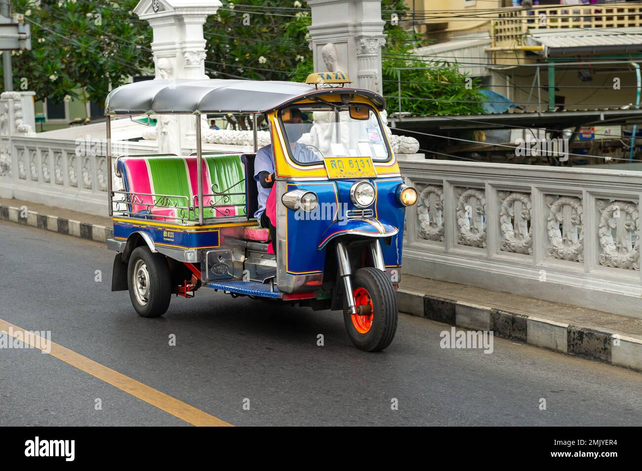 Moving Tuc Tuc crossing the canal bridge on Boripat Road, Bangkok, Thailand Stock Photo