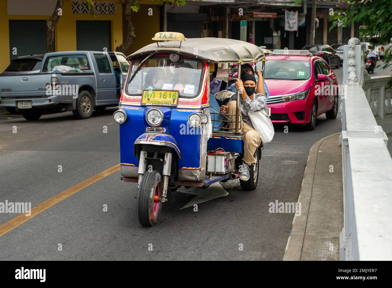 Moving Tuc Tuc crossing the canal bridge on Boripat Road, Bangkok, Thailand Stock Photo