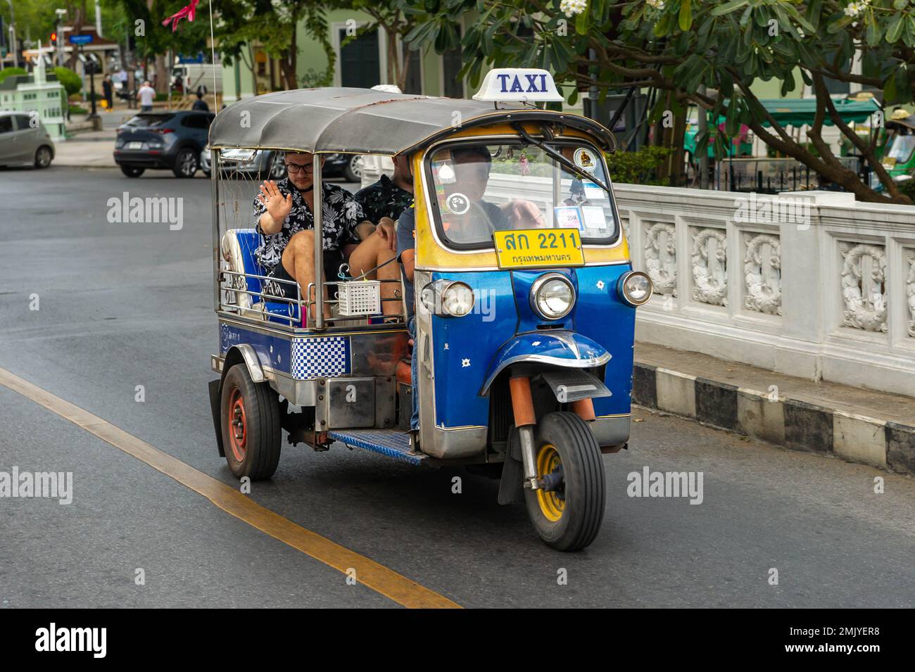Moving Tuc Tuc crossing the canal bridge on Boripat Road, Bangkok, Thailand Stock Photo