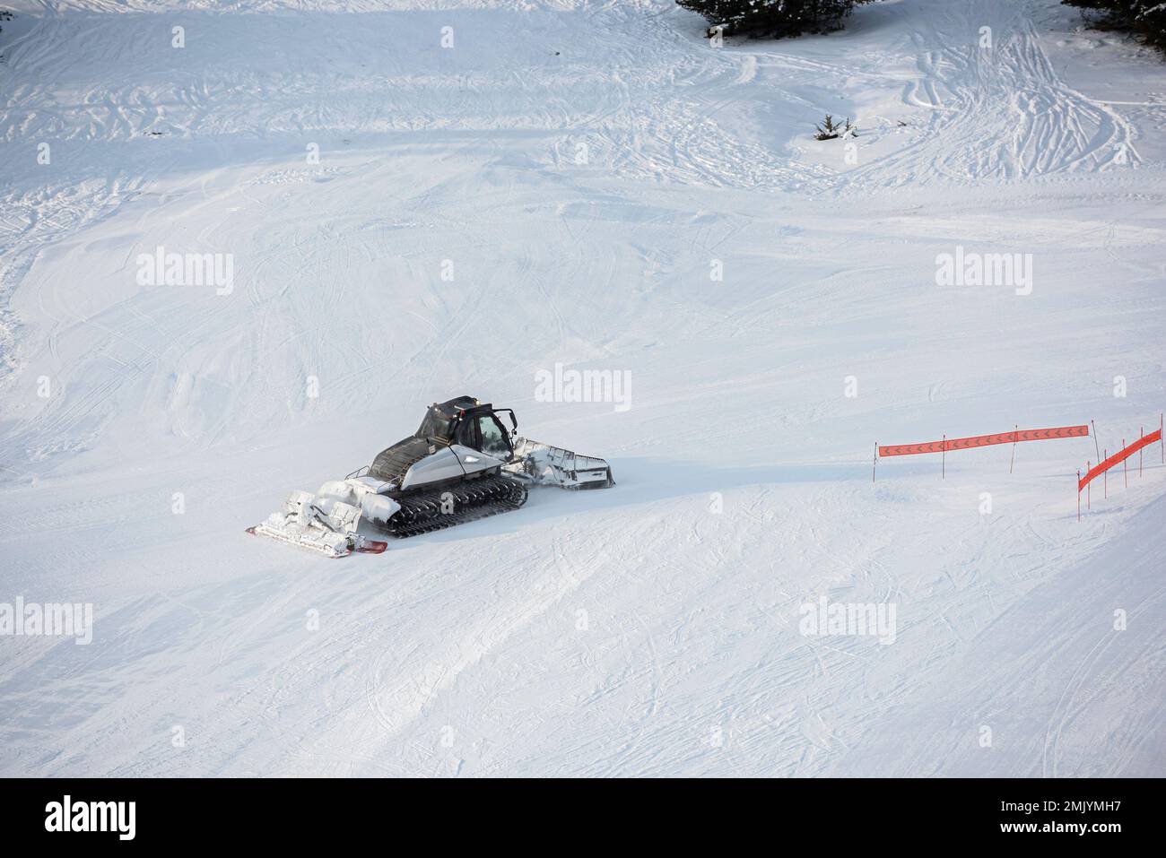 Snow groomer on a ski slope, Ski resort in the Alps, France Stock Photo