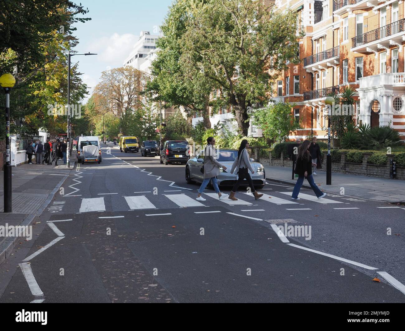 LONDON, UK CIRCA OCTOBER 2022 People crossing Abbey Road zebra