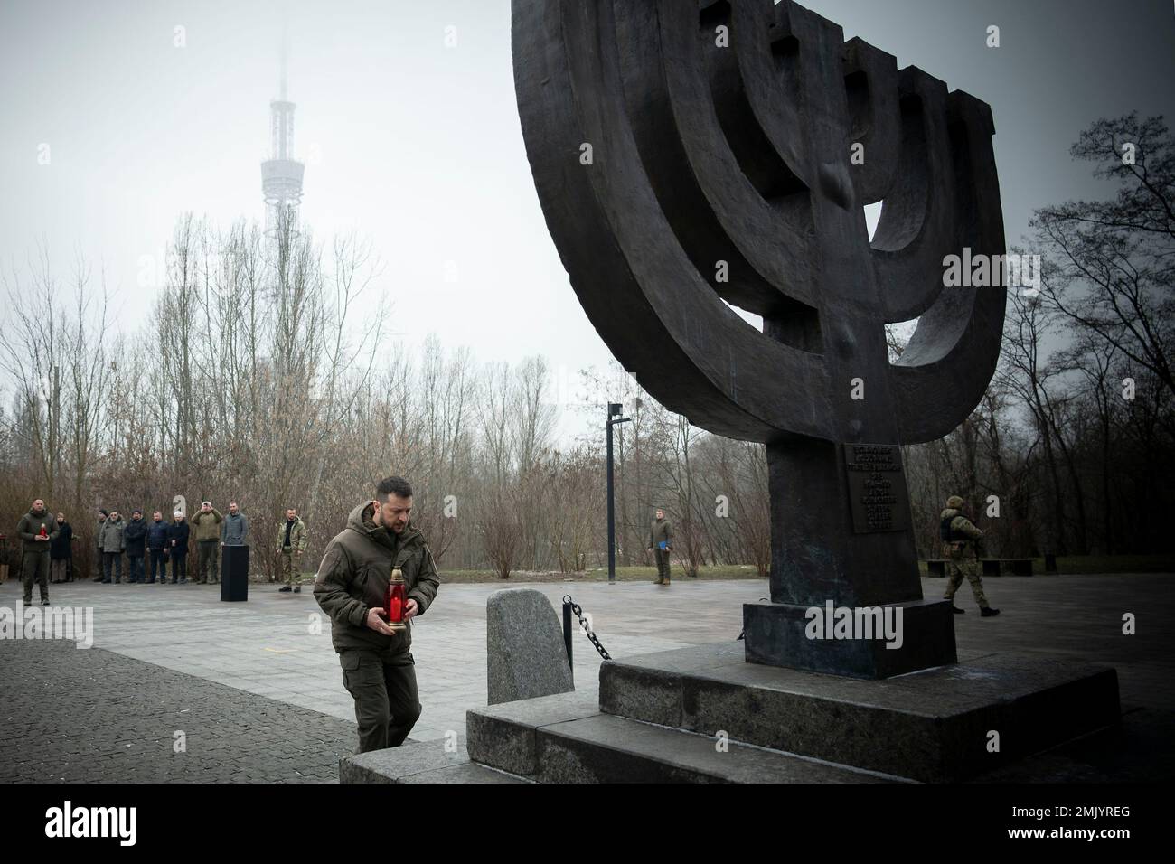 Kyiv, Ukraine. 27 January, 2023. Ukrainian President Volodymyr Zelenskyy places a candle at the Menorah memorial to commemorate International Holocaust Remembrance Day at the Babyn Yar National Historical Memorial site, January 27, 2023 in Kyiv, Ukraine.  Credit: Ukraine Presidency/Ukrainian Presidential Press Office/Alamy Live News Stock Photo