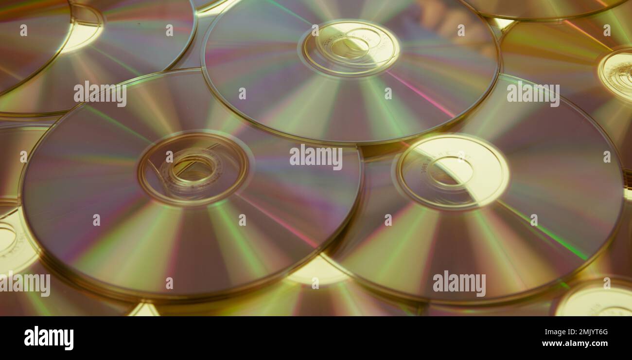 golden compact discs background gold disc cdrom Cd or Dvd Blue ray Stock Photo