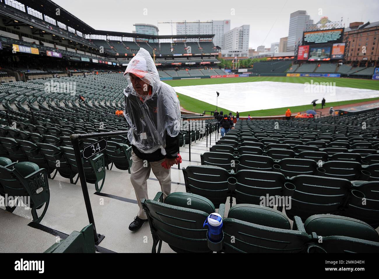 A tarp covers the field during a rain delay in a baseball game between
