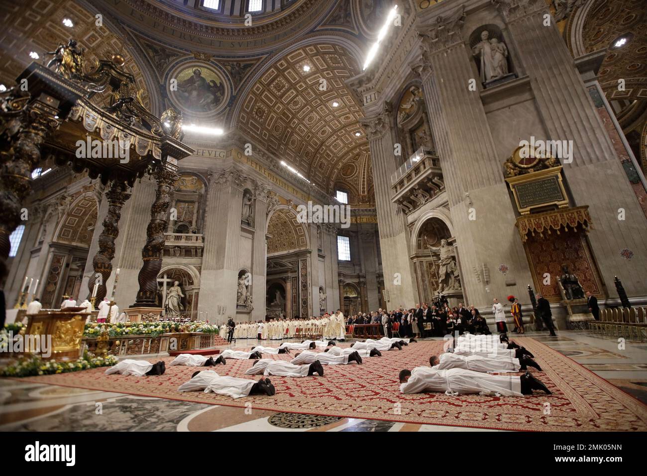 Priests lie face down on the floor during an ordination ceremony presided over by Pope Francis