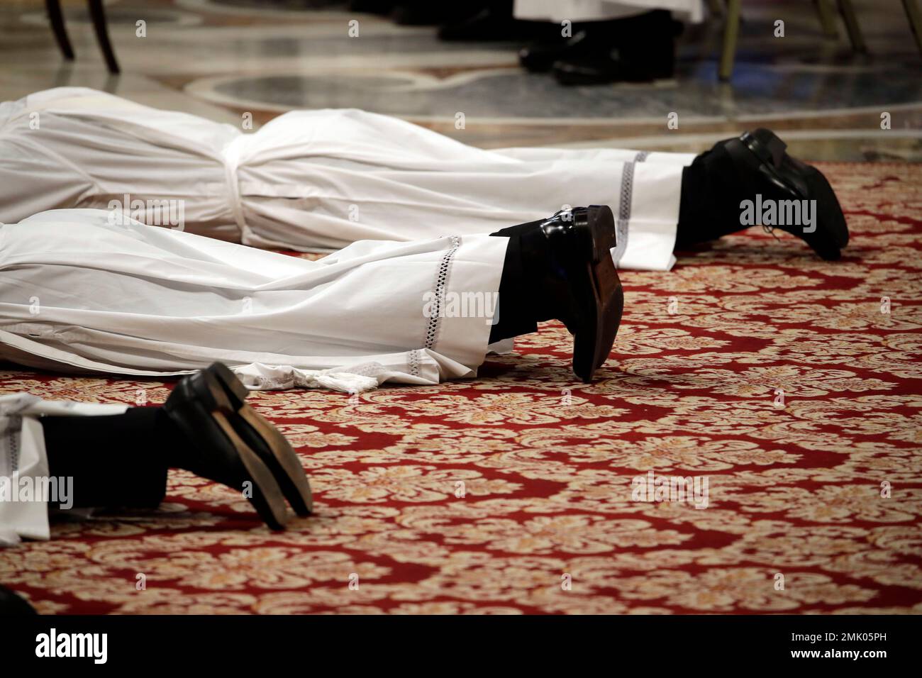 Priests lie face down on the floor during an ordination ceremony presided over by Pope Francis