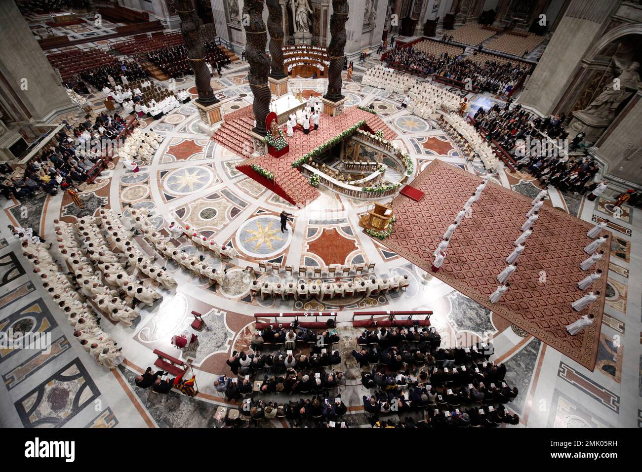 Priests lie face down on the floor during an ordination ceremony presided over by Pope Francis