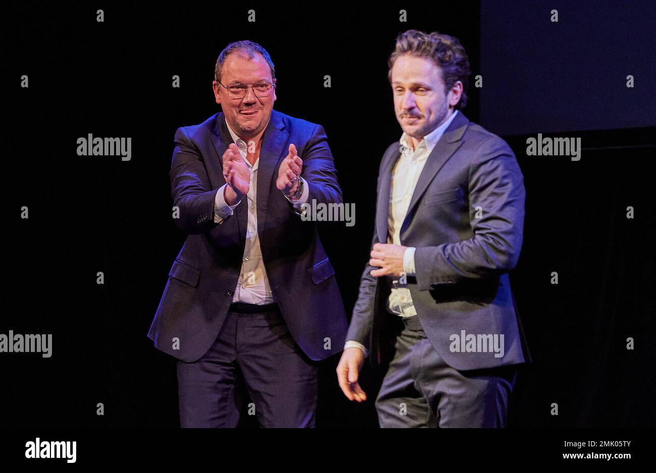 Hamburg, Germany. 28th Jan, 2023. Charly Hübner (l), laudator and actor,  and award winner Dimitrij Schaad, actor, stand on stage at the St. Pauli  Theater during the Ulrich Wildgruber Award ceremony. Credit: